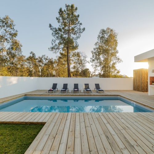Modern house with garden swimming pool and wooden deck
